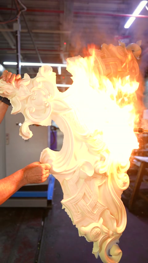 Large flames cover the right edge of an embossed decorative piece.