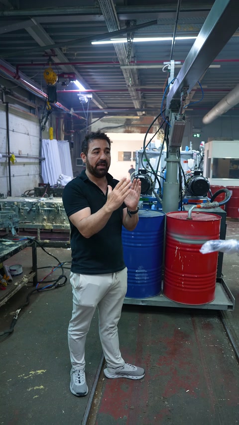 A workshop employee provides information about the test near barrels.