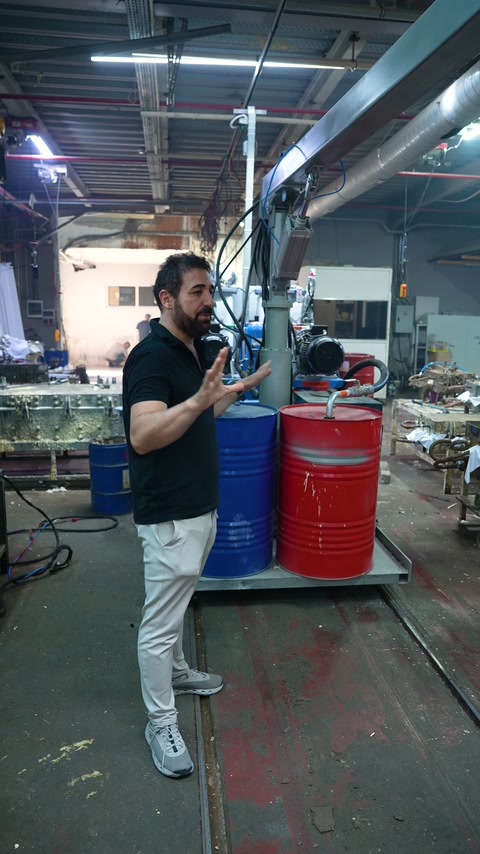 An official speaks inside the factory and shows equipment in the test area.
