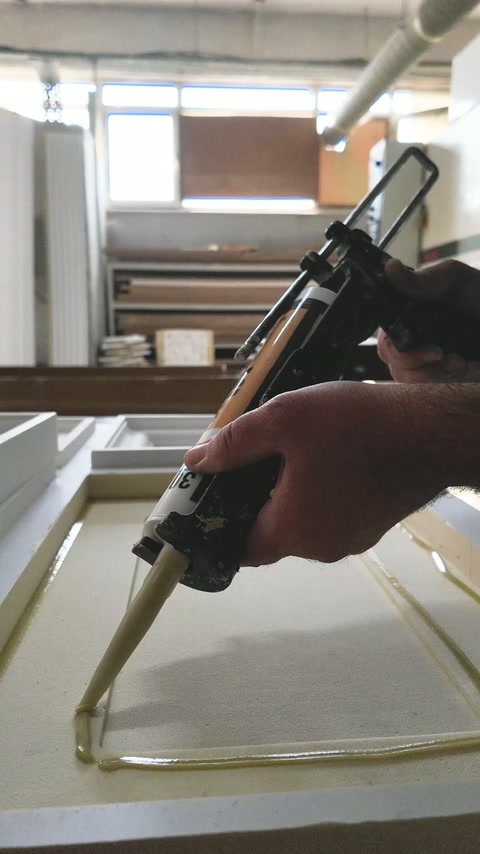Adhesive is applied around a recessed rectangular panel component