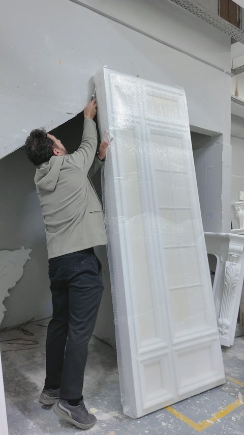 Protective wrapping is removed from the completed tall panel section