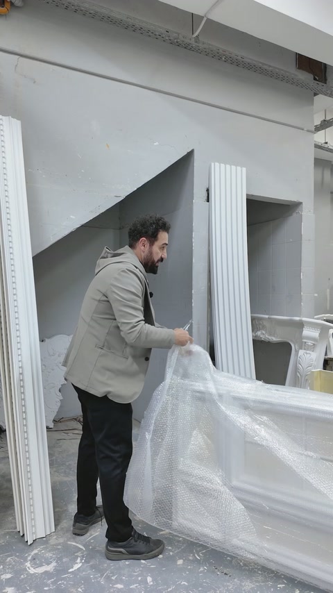 A rectangular moulded panel is uncovered from protective packaging