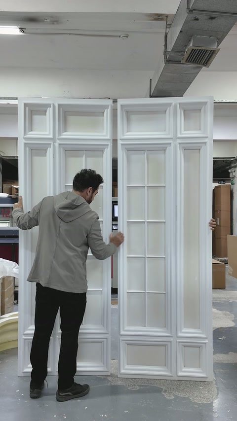 Worker aligns a narrow side panel beside the central composition