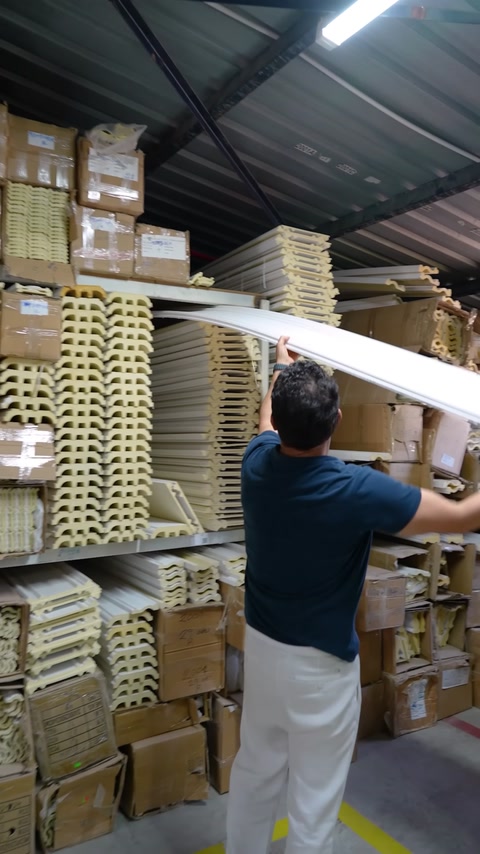Long curved profile product is examined between shelves