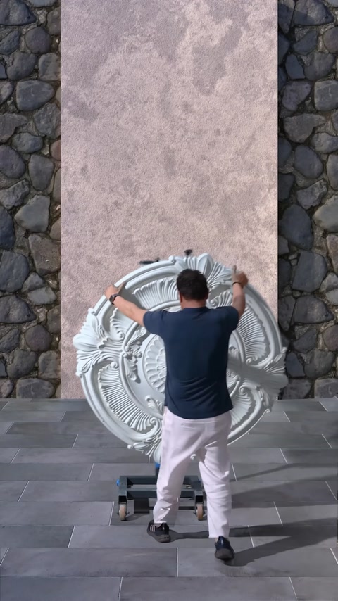 Large ceiling medallion is positioned on wall design