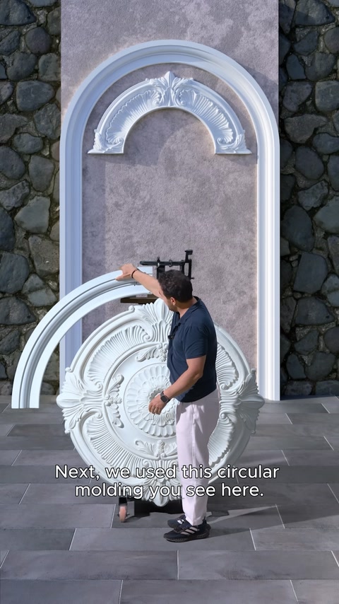 Circular molding is installed below the arch in design