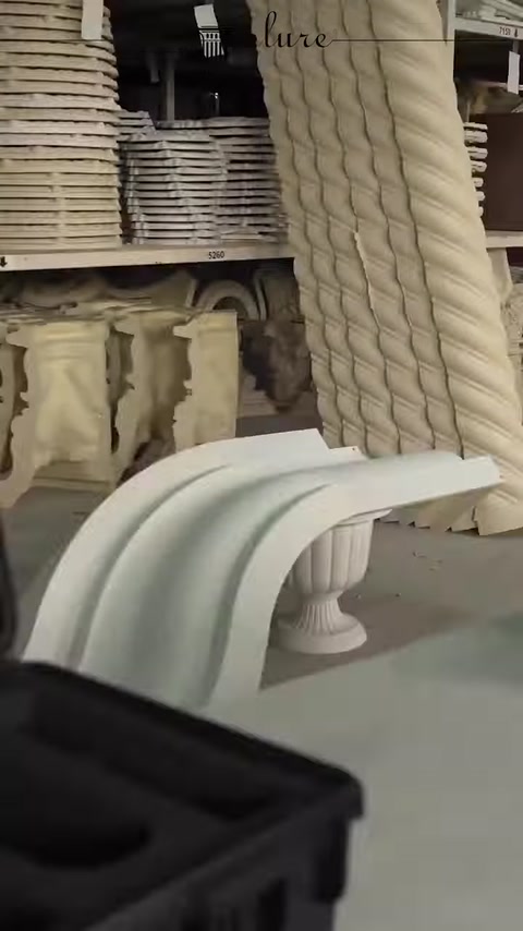 Corbel examples and twisted column pieces are displayed together in the workshop