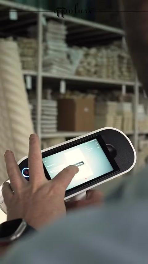 The operator manages recording settings on the scanning device's touchscreen