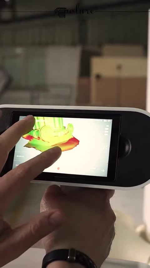 A colored three-dimensional model of the column base is examined on the scanning screen