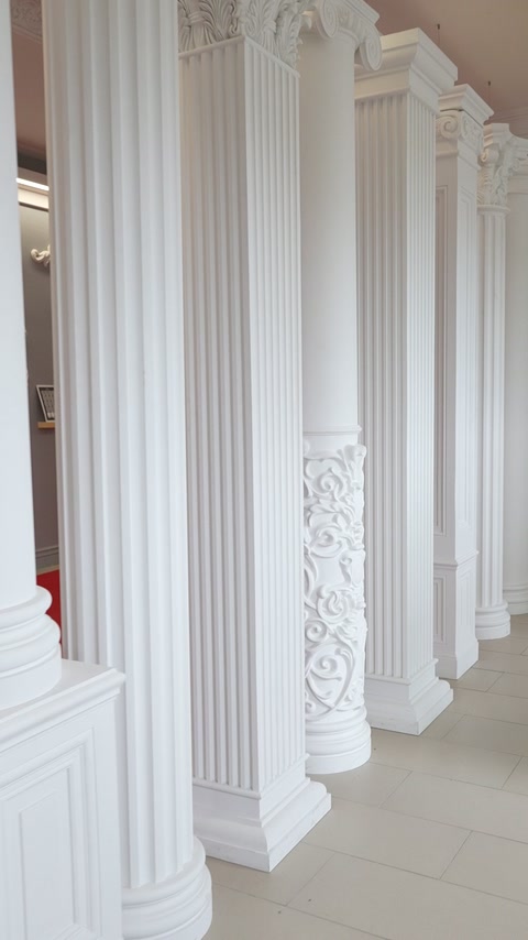 Fluted columns with carved bases create an elegant interior colonnade