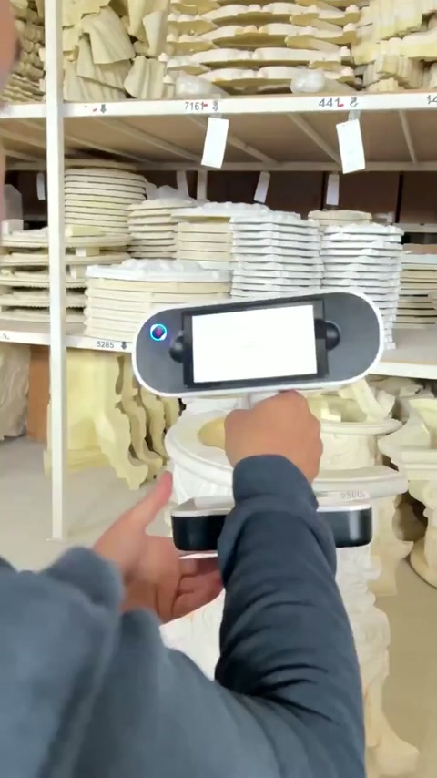Handheld scanner captures the detailed surface of an ornate capital
