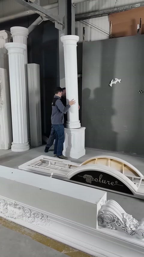 Worker attempts to place the column body on a square base.