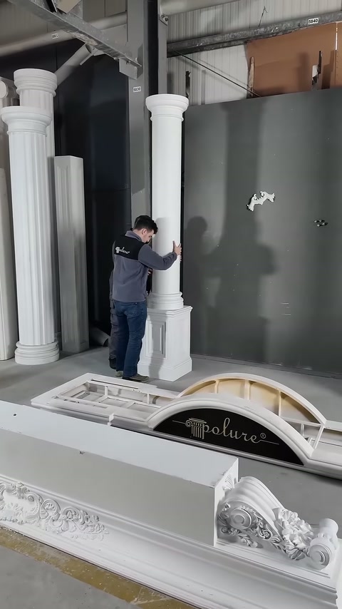 Worker controls the alignment of the vertical column with its base by hand.