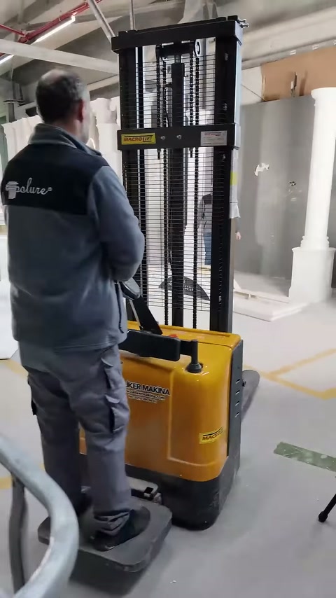 Lifting machine carefully advances in front of decorative products.