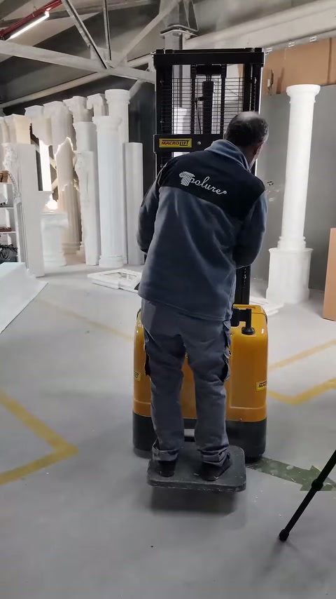 Worker directs the yellow lifting machine in the installation area.