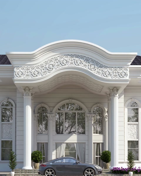 Villa entrance facade with ornate polyurethane pediment and columns.