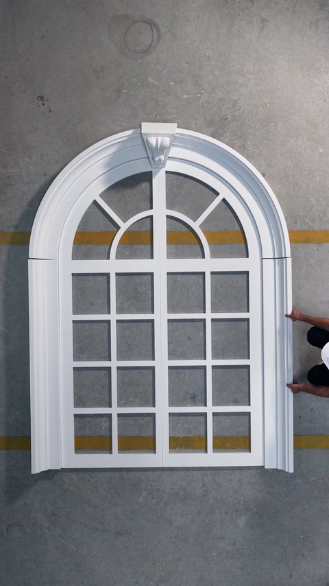 Arched window frame with polyurethane surround and grid panes.