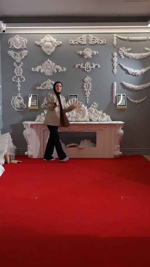 Carrying a polyurethane capital piece across a showroom floor