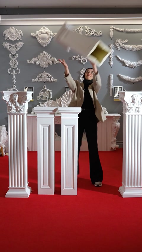 Placing a capital atop assembled polyurethane pedestal columns