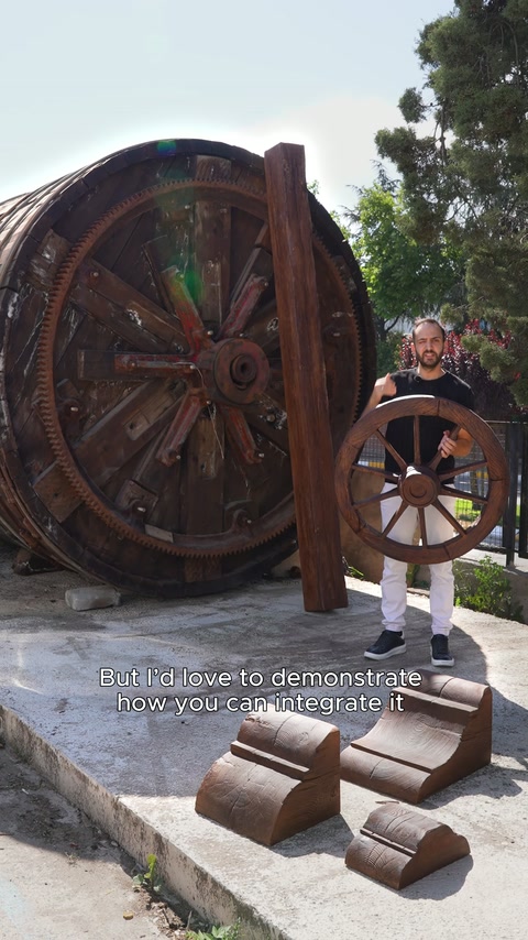 A presenter displays a small wheel model in front of the giant wheel