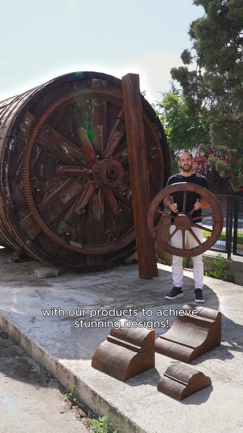 A presenter holds a decorative wheel example for use in a rustic setting