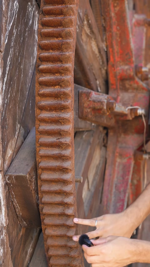An embossed brown strip is shown up close on the weathered wheel surface