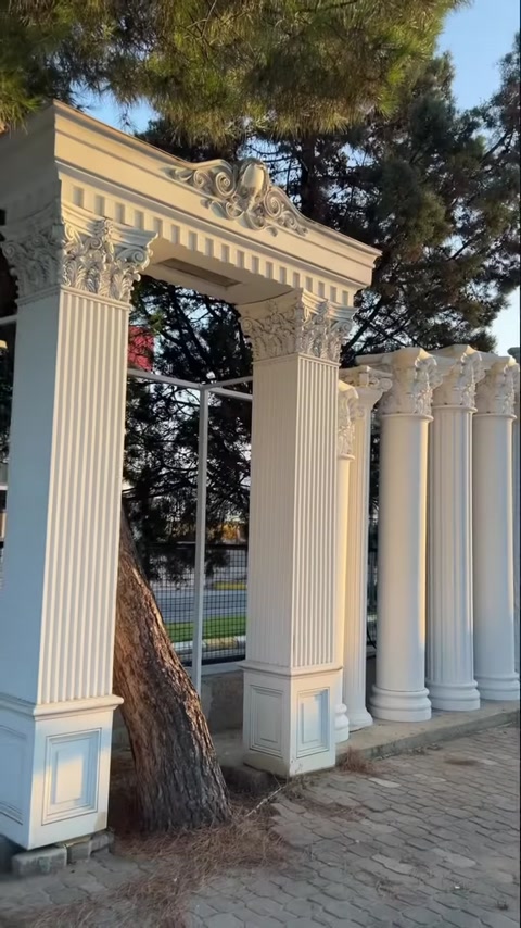 Arched entrance design with arranged column models in an outdoor setting