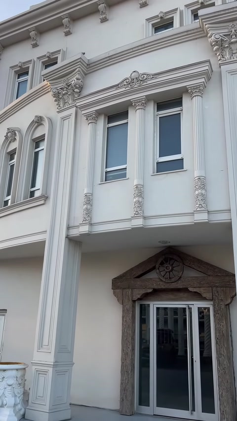 Slim decorative columns complementing window surrounds on a building facade