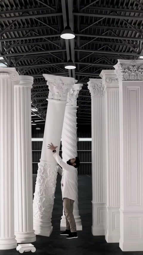 Production area with a model being manually placed between fluted columns