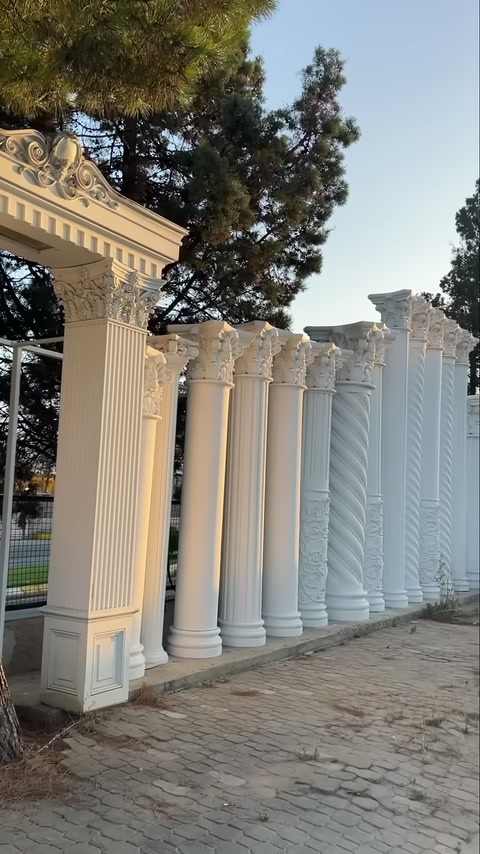 White columns with various shaft patterns displayed along garden edge