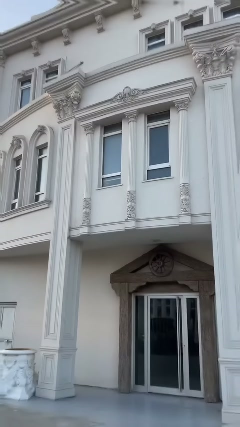 Villa facade with thin column ornaments framing balcony windows
