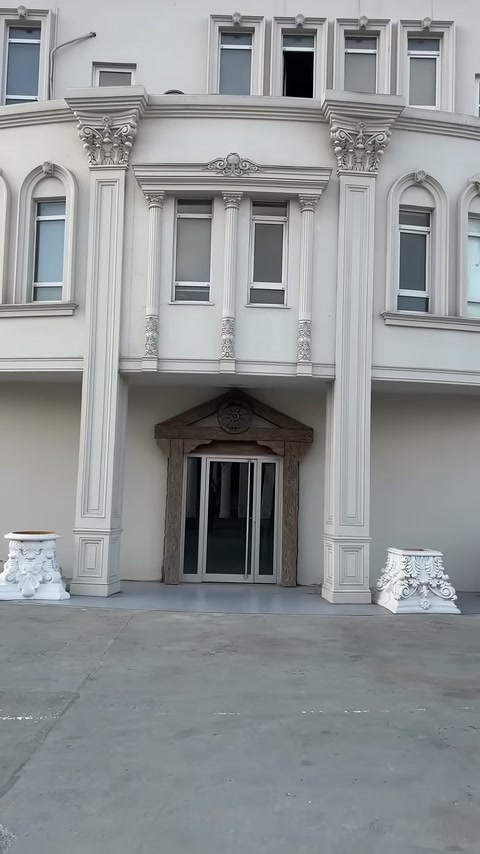Villa entrance facade showing columns, pilasters, and window surrounds
