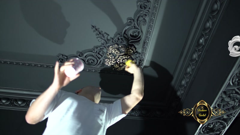Applying Gold-Effect Paint with a Brush over Black Ceiling Decorations