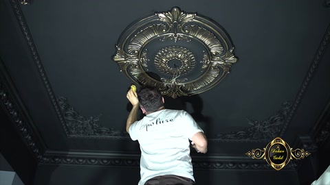 The completed gold details on the ceiling medallion are viewed from the front