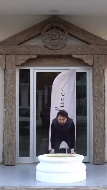 Decorative round base being placed on the ground at the entrance