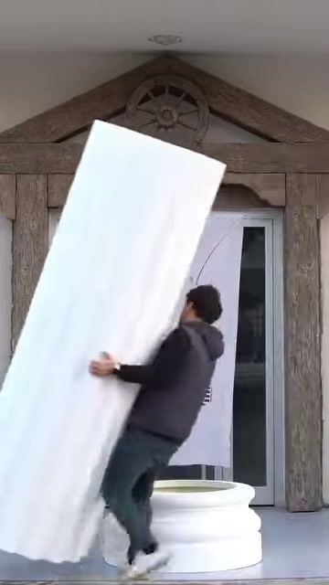 Large fluted shaft being directed toward the base with both hands