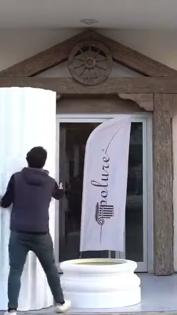 White fluted shaft being raised in front of the doorway