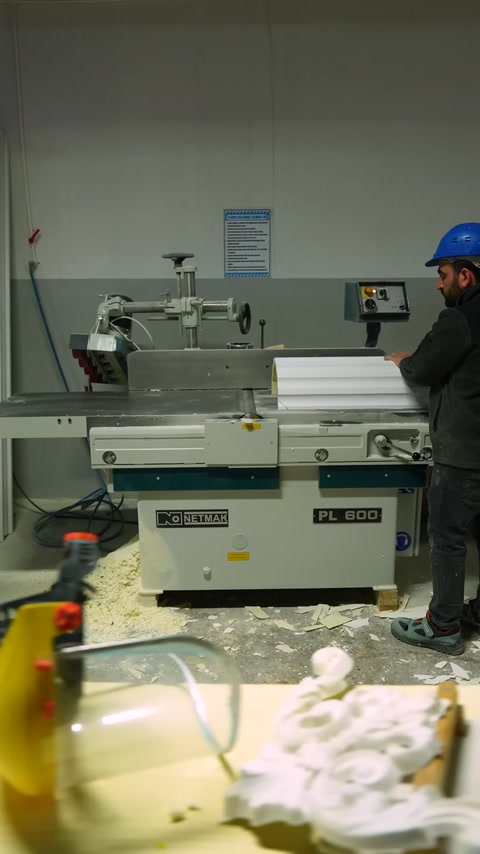 An industrial cutting machine used to process decorative parts is shown