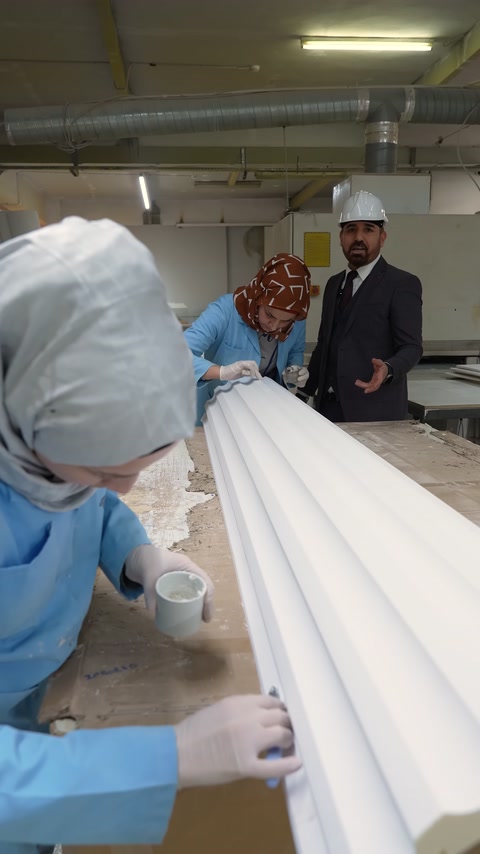 A long white decorative profile is carefully finished with a brush