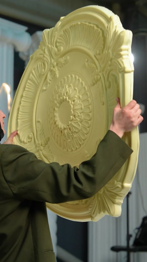 Close view of round ceiling medallion with detailed floral carving