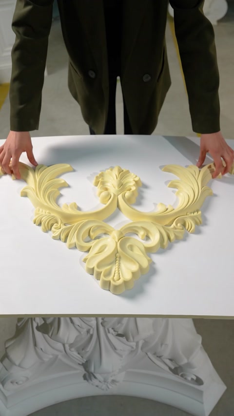 Flexible scroll cornice piece laid flat on white worktable