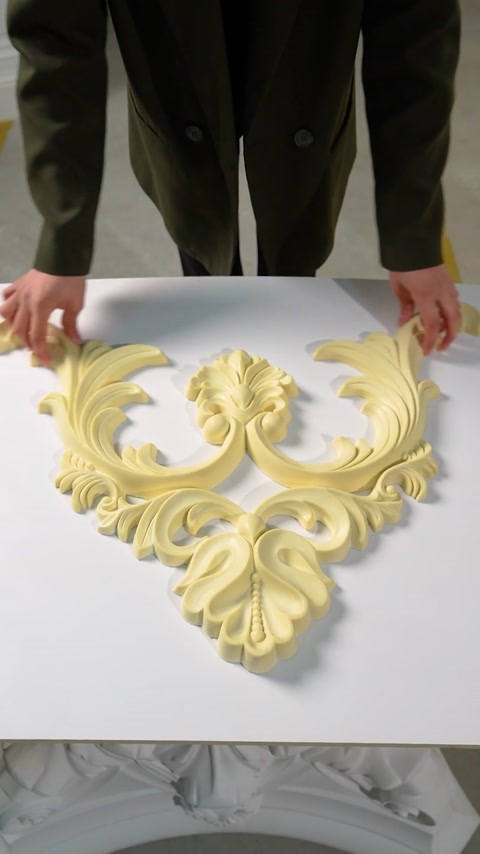 Second view of scroll shaped cornice piece on table