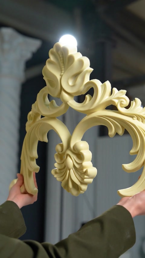 Close-up of ornate scroll and acanthus leaf cornice detail