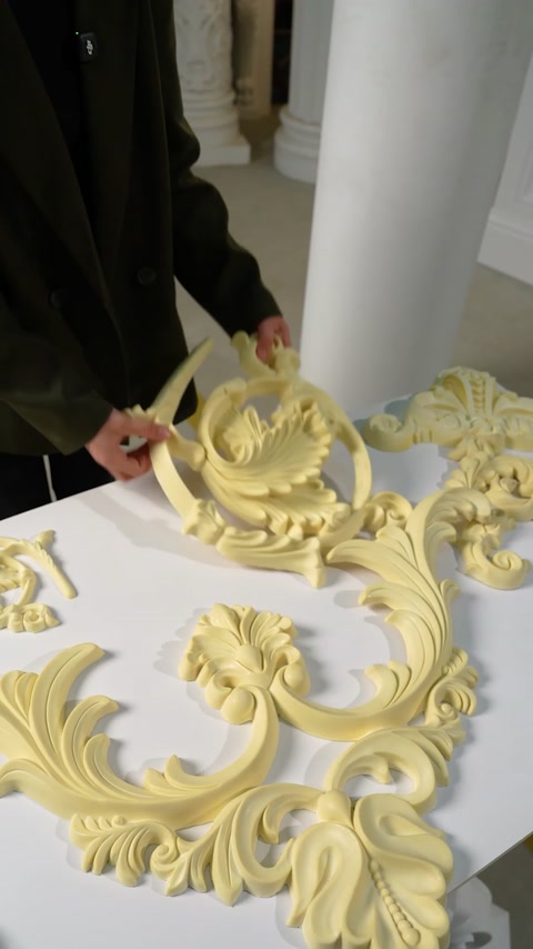 Multiple flexible ornament pieces arranged for ceiling assembly