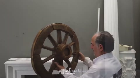 Examining details of a decorative carriage wheel's rose and spoke pattern