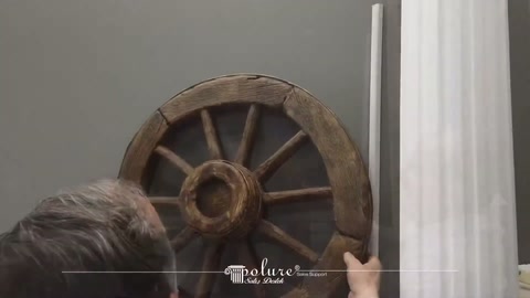 Two rustic wheel models displayed on the wall next to the server