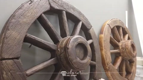 Viewing distressed surface and rose details of two decorative wheels