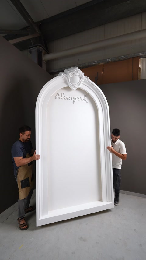 A niche surrounded by a floral-patterned arch and layered trim is shown