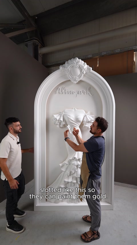 The craftsman explains the structure of the removable lettering pieces before painting