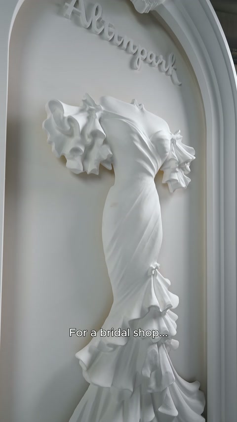Le ruches sulle spalle e la forma attorcigliata in vita del rilievo dell'abito da sposa sono esaminate lateralmente